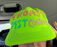 a woman wearing a hat that says toast pest control